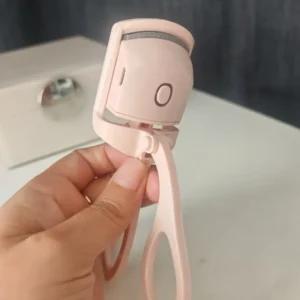 Rizador de pestaña eléctrico rosado frente.